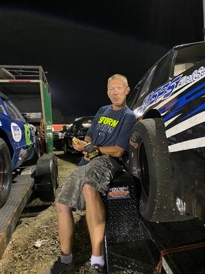 Petey, Crew Chief, sitting on a race car trailer
